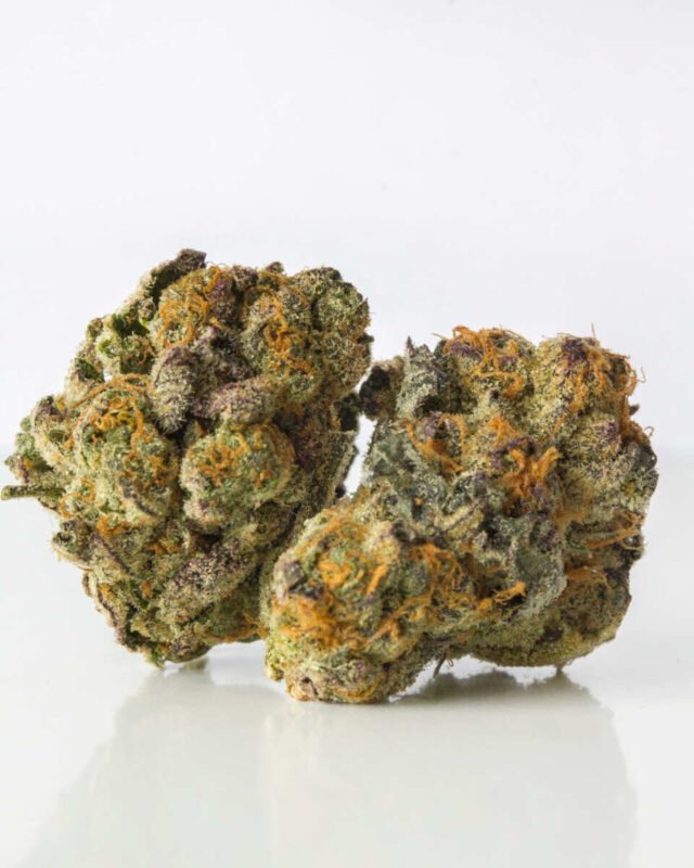 Close-up of Lemon Cake cannabis strain buds, showcasing bright green leaves and trichome crystals with a hint of citrus aroma.