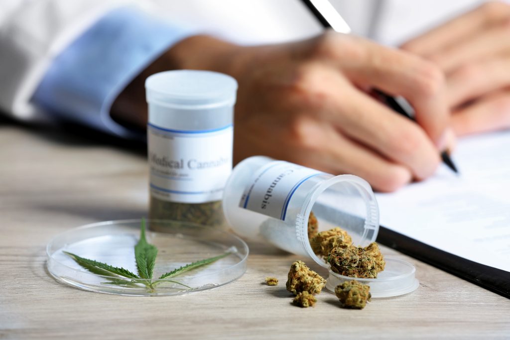 Close-up of cannabis leaves and a cannabis product, symbolizing the use of cannabis for managing disabilities.